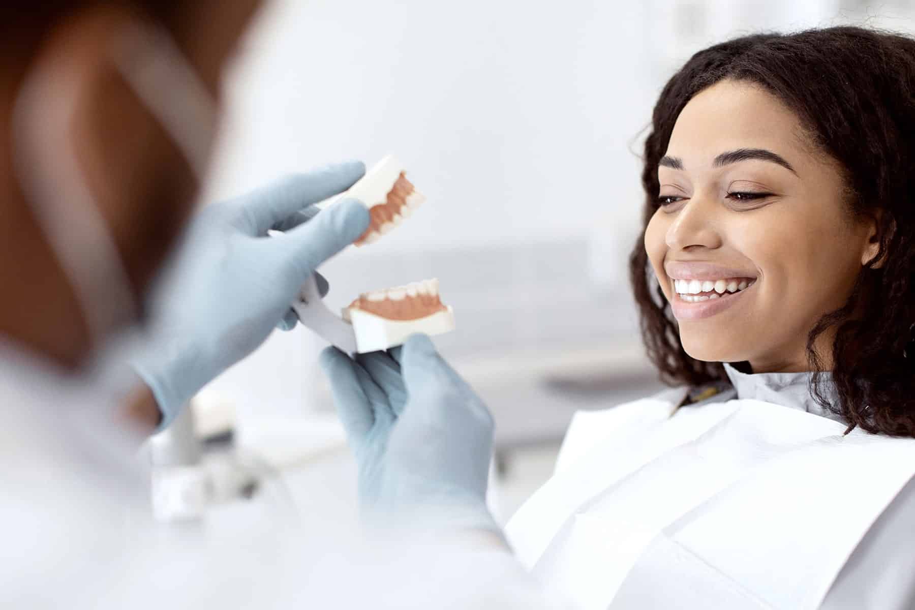 ExquisiteDentalImplants2-min Woman at dental implant consultation in Sandy Springs, GA