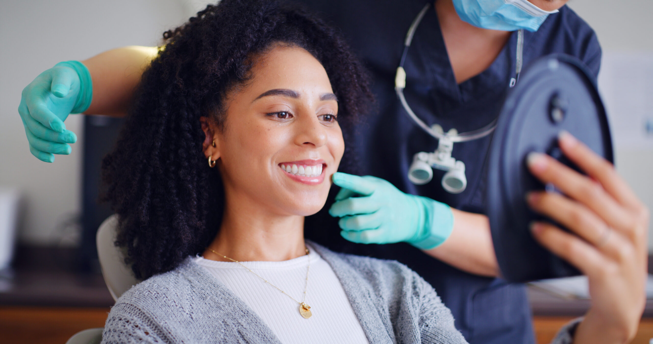 Woman, smile and mirror for checkup with dentist, oral hygiene and mouth cleaning service. Female person, assessment and orthodontic inspection for dental care, patient and help for consultation.