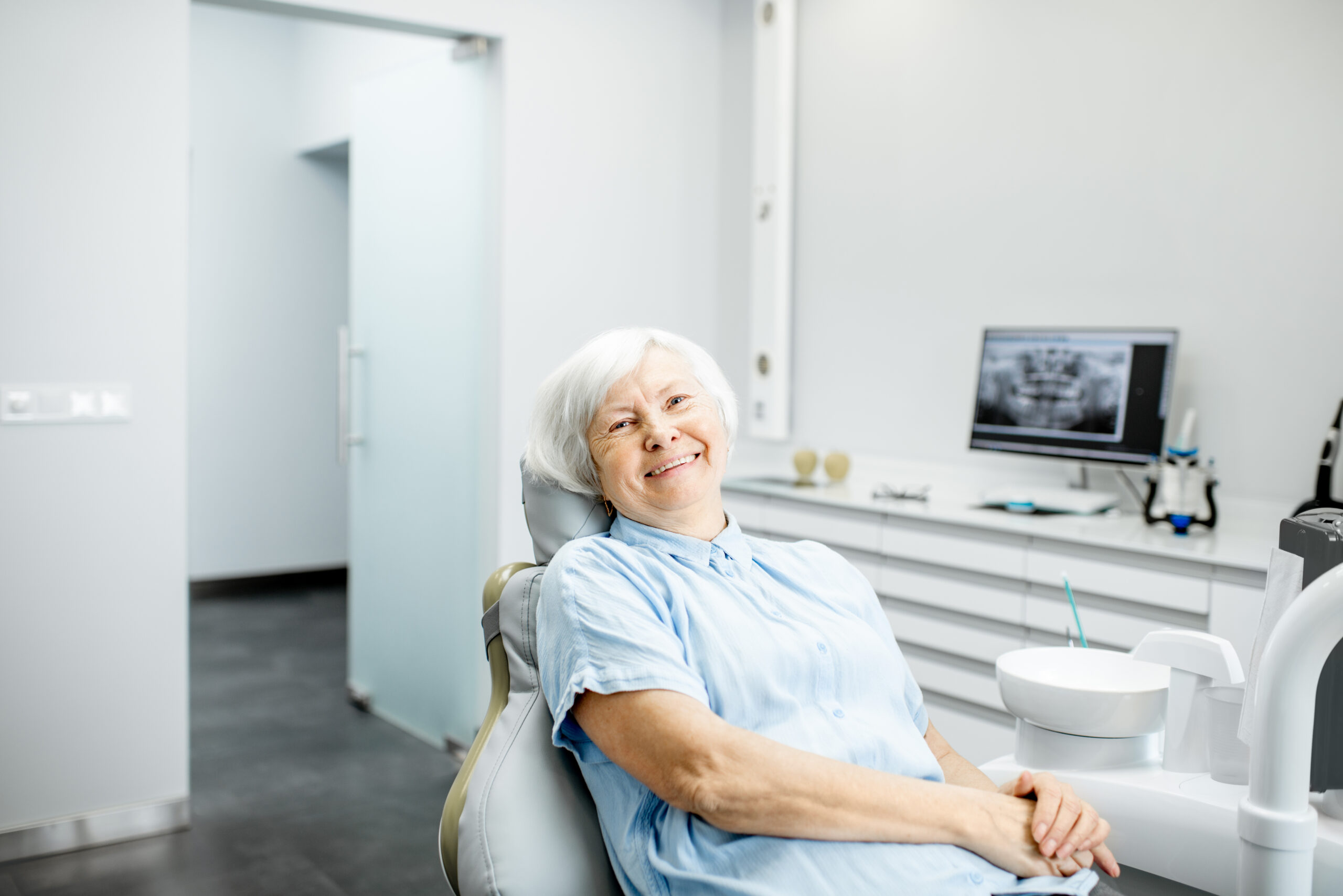 Senior woman with a healthy smile sitting at the dental office